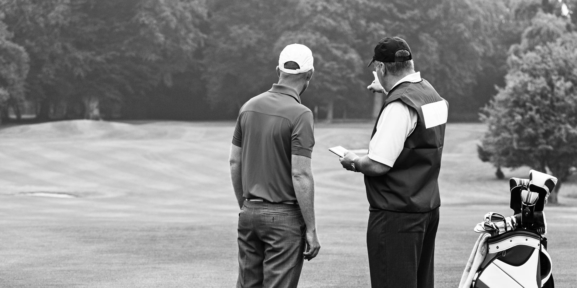 Golfer and Caddie Discussing Strategy
